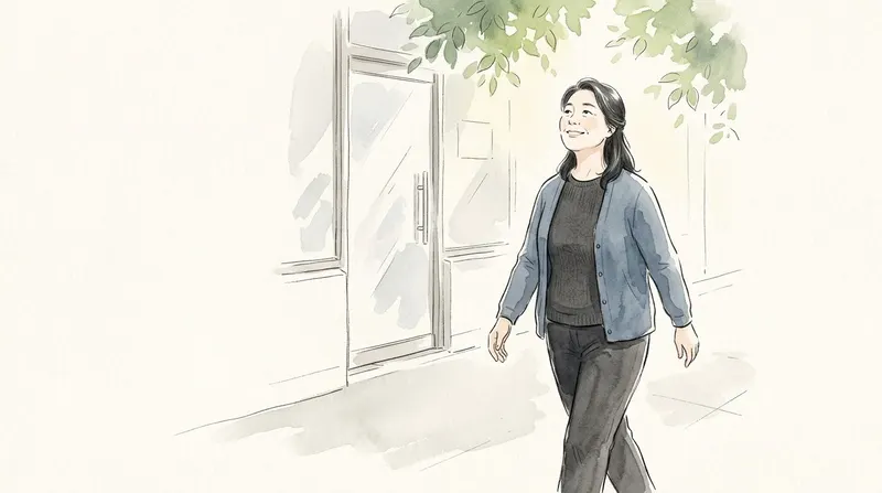 Woman walking out along a sunny tree-lined sidewalk, smiling